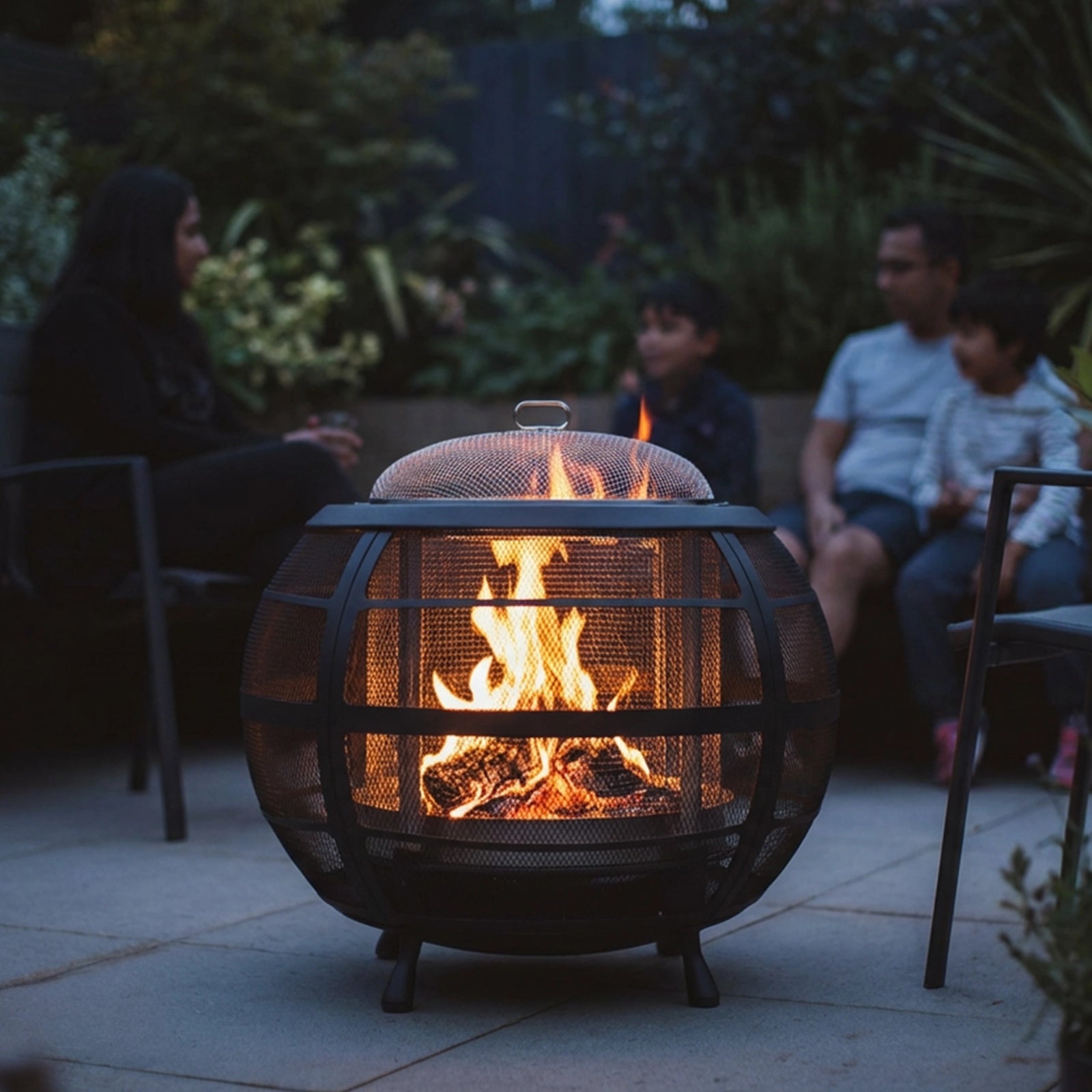 Fire pit with people sitting around at dusk