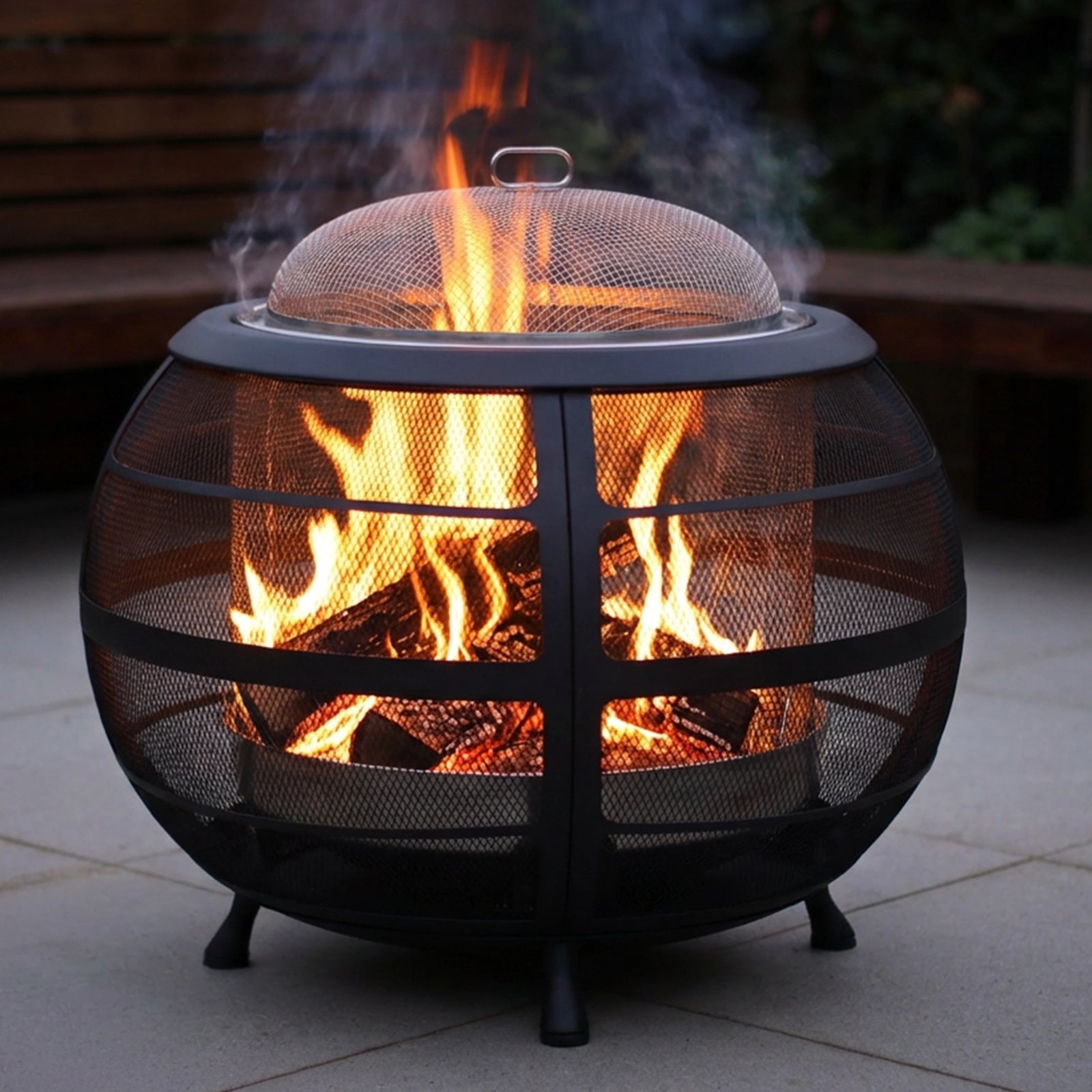 Mesh fire pit with flames on a patio